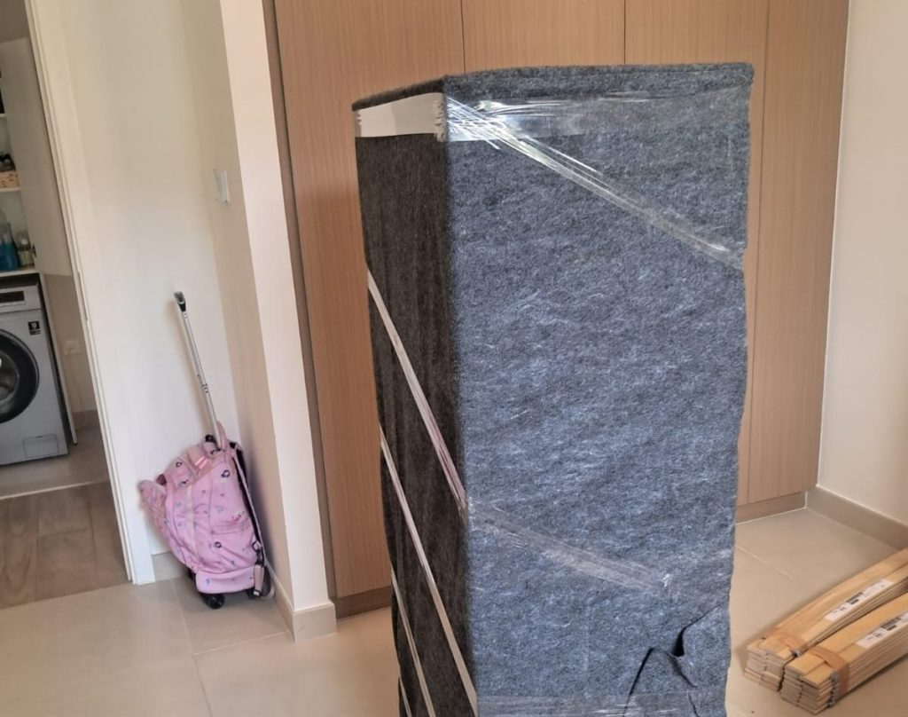 Affordable movers and packers providing professional relocation service with team carefully packing and loading household furniture, boxes, and items into a moving truck for safe transport.