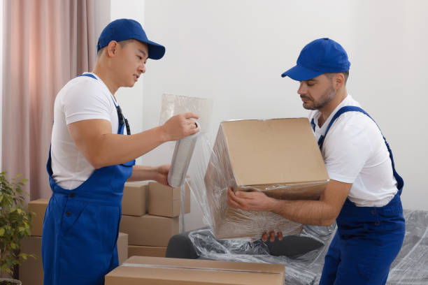 Movers in Mirdif Dubai providing professional relocation service with team carefully packing, loading, and transporting household furniture, boxes, and items into a moving truck outside a residential building.