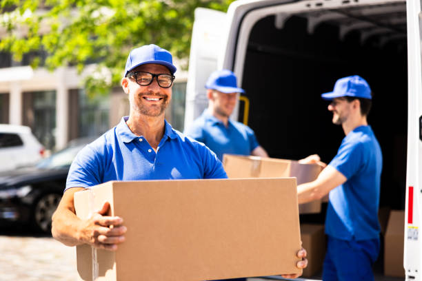 Villa movers in Karama Dubai providing professional relocation service with team carefully handling, packing, and loading luxury furniture, sofas, beds, boxes, and household items into a moving truck outside a residential villa.